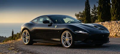 Ferrari Roma — black grand-tourer on a coastal road